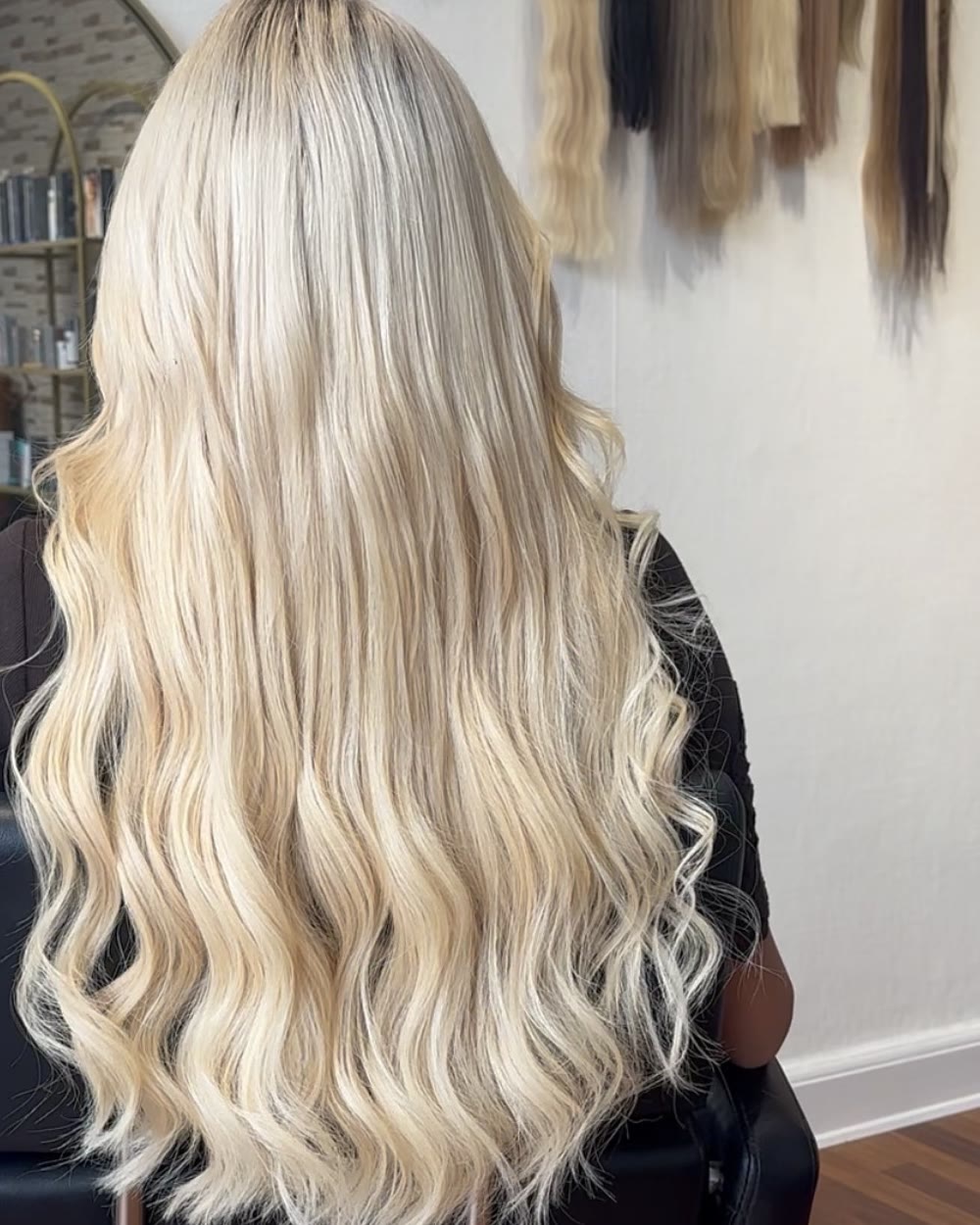 Long blonde waves with extensions, seen from behind at the Princess Beauty salon